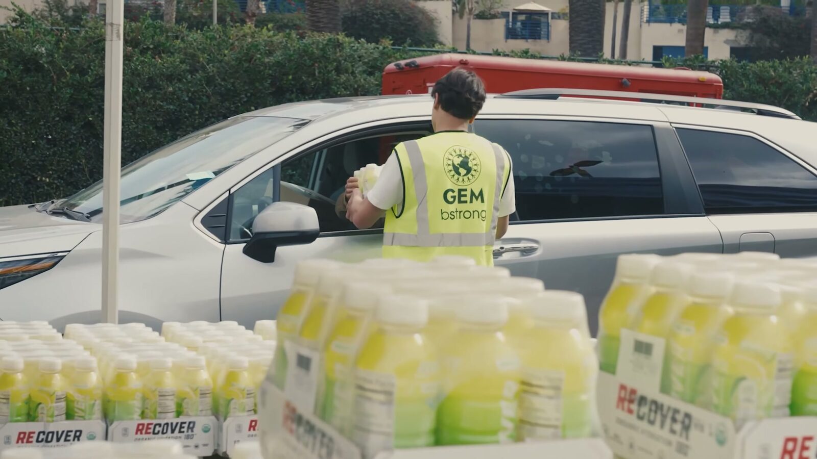 A Global Empowerment Mission volunteer loading supplies into a car