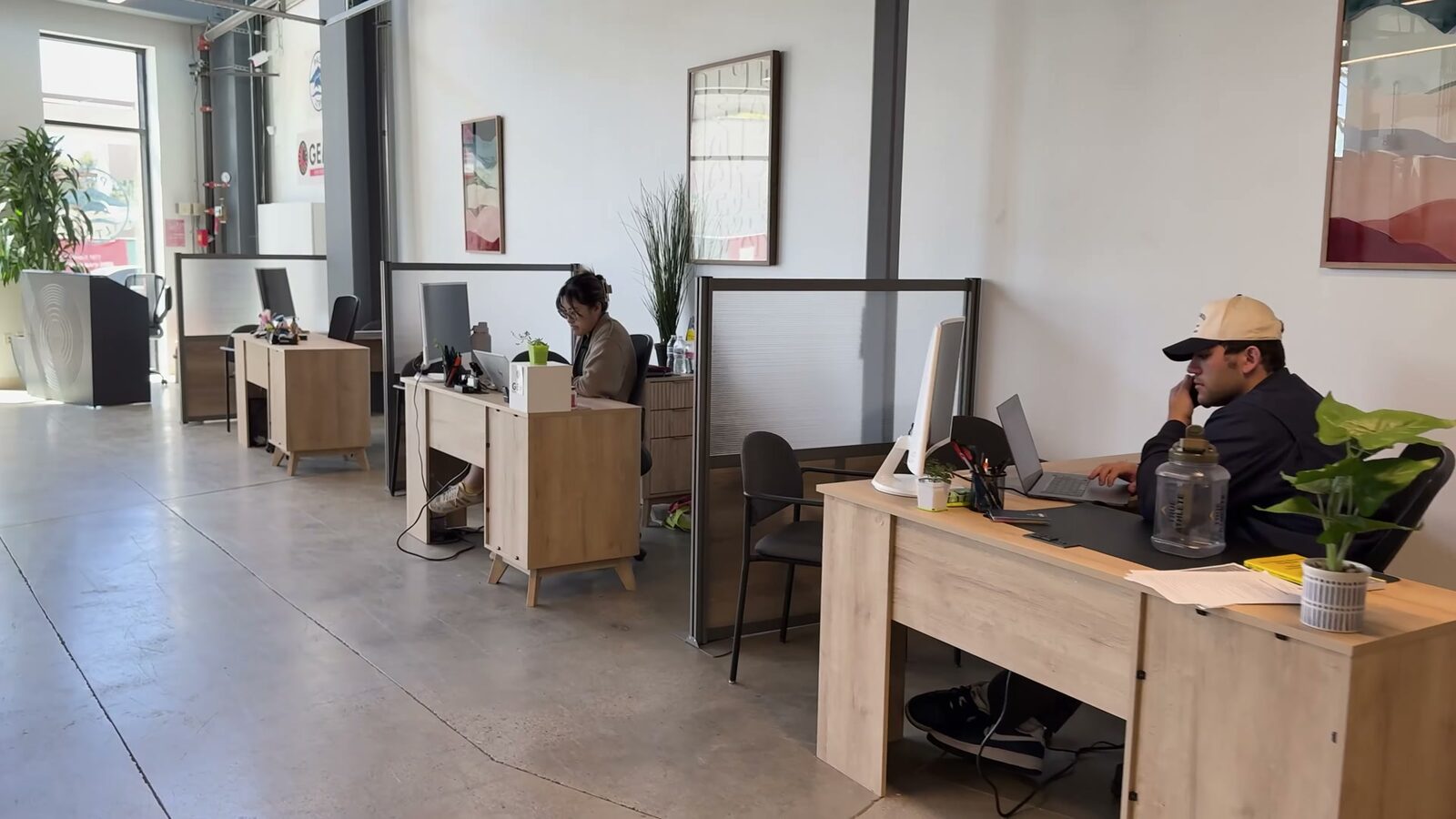 Caseworkers at desks on the Pali Hub's open work floor
