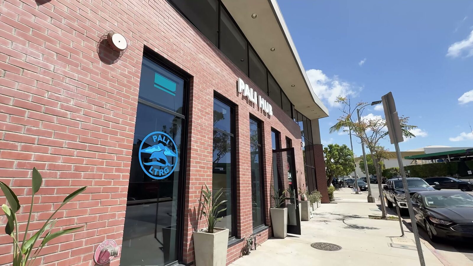 The Pali Hub's brick frontage, the Pali LTRG dolphin seal on the window and the PALI HUB sign above it