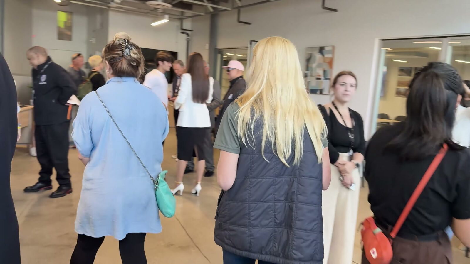 Visitors talking with staff inside the Pali Hub on opening day