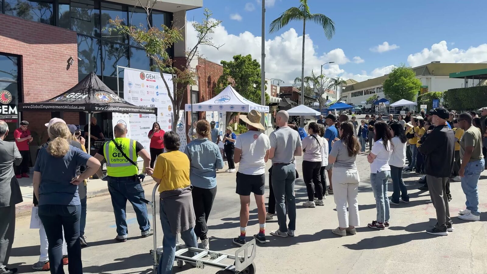 Partner organizations' tents lining the street outside the Pali Hub on opening day